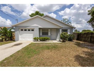 Charming single-story home featuring a one-car garage and a well-maintained front yard at 13 N Observatory Dr, Orlando, FL 32835