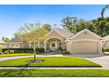 Charming single-story home with well-manicured lawn and inviting curb appeal on a sunny day at 189 Hammock Oak Cir, Debary, FL 32713