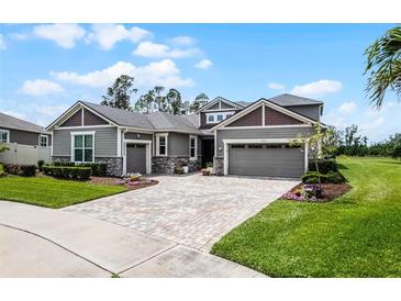 Charming home with a well-maintained lawn, beautiful landscaping, and a stylish driveway at 1910 Donahue Dr, Ocoee, FL 34761