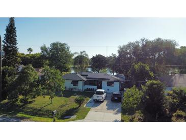 Inviting single story home featuring solar panels, mature trees, and a well manicured lawn in a lakefront community at 2154 Lake Christie Dr, Orlando, FL 32809