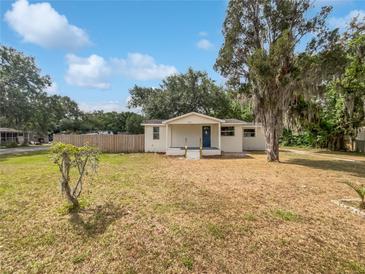 Charming single-story home featuring a well-maintained lawn and inviting blue door at 2845 Ellis Ave, Lakeland, FL 33803
