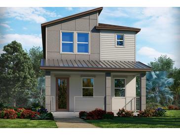 Charming two-story home with modern design, front porch, and beautifully landscaped yard at 4549 Cross Prairie Pkwy, St Cloud, FL 34772