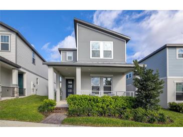 Charming two-story home features a modern design, landscaped yard and welcoming front porch at 4875 Lacewing Dr, Winter Garden, FL 34787