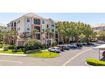 Attractive condominium building with parking and beautiful landscaping at 8296 Portofino Dr # 405, Davenport, FL 33896