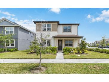 Charming two-story home with a well-manicured lawn and beautiful landscaping at 8573 Lamppost Ln, Orlando, FL 32832
