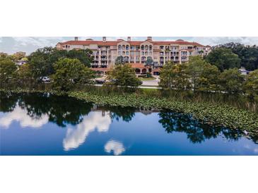 Luxury lakeside condo building with lush landscaping and serene water views offers resort-style living at 1110 W Ivanhoe Blvd # 15, Orlando, FL 32804