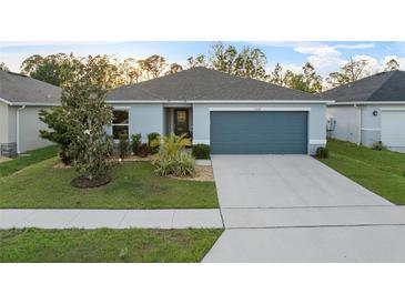 Charming single-story home with a well-maintained lawn and attached two-car garage at 1328 Pompay Dr, Davenport, FL 33896
