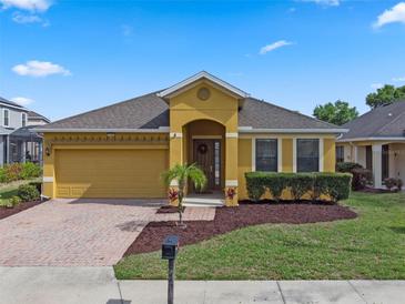 Charming single-story home with a well-maintained lawn and colorful landscaping at 2142 Victoria Dr, Davenport, FL 33837