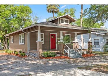 Charming bungalow-style home features a red front door and a welcoming front porch at 216 S Holly Ave, Sanford, FL 32771
