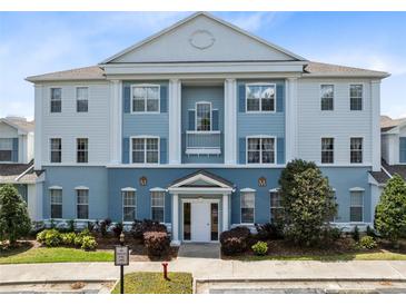 Stunning condo exterior boasts classic architecture, blue accents, and well-maintained landscaping at 7649 Heritage Crossing Way # 302, Reunion, FL 34747