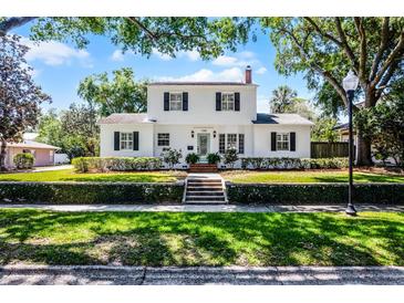 Charming white two-story home featuring classic black shutters and lush landscaping at 1106 Ayrshire St, Orlando, FL 32803