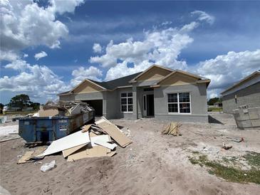 New construction home with a modern design, showcasing large windows and a spacious two-car garage at 2643 Ravencliffe, Oviedo, FL 32765