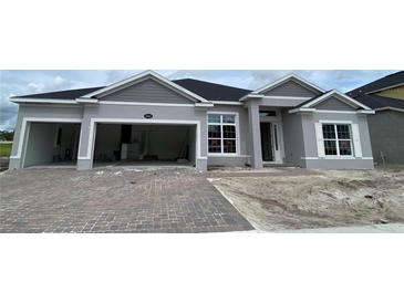 Charming single-story home with a two-car garage and brick paver driveway is waiting for landscaping at 2643 Ravencliffe Ter, Oviedo, FL 32765