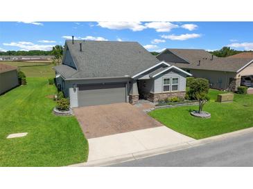 Beautiful single Gathering home with a well-manicured lawn and paver driveway at 4687 Nw 35Th Lane Rd, Ocala, FL 34482