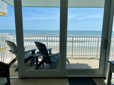 Relaxing balcony with Adirondack chairs and a stunning ocean view at 5203 S Atlantic Ave # 416B, New Smyrna Beach, FL 32169