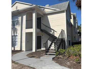 Exterior view of two story condo building with stairs leading up to the units at 1055 S Hiawassee Rd # 2018, Orlando, FL 32835