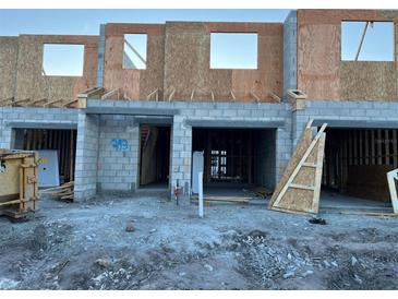 A new construction townhouse featuring a concrete block foundation and wood framing during the building process at 14910 Harvest St, Orlando, FL 32824