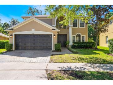 Inviting two-story home with a well-manicured lawn and a two-car garage at 1563 Song Sparrow Ct, Sanford, FL 32773