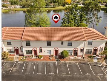 Inviting townhouse near the lake featuring a red-tiled roof and reserved parking spaces at 1631 Long Ridge Ct # 268, Orlando, FL 32807