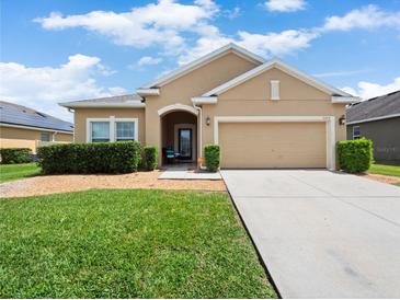 Charming single-story home with a well-maintained lawn and inviting curb appeal on a sunny day at 3505 Rhapsody St, St Cloud, FL 34772