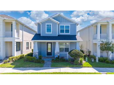 Charming two-story home featuring a covered porch and well-manicured lawn for curb appeal at 4233 Mistwood St, Winter Garden, FL 34787