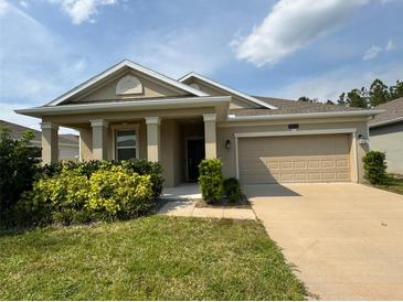 Charming single-story home with a well-manicured lawn and inviting front porch at 5550 Bakewell Pl, St Cloud, FL 34771