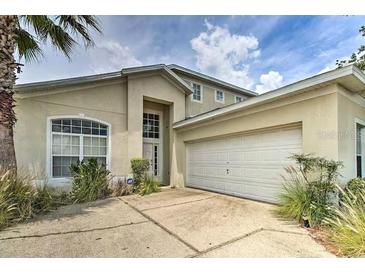 Charming home featuring an attached two car garage and well-maintained landscaping at 730 Bloomingdale Dr, Davenport, FL 33897