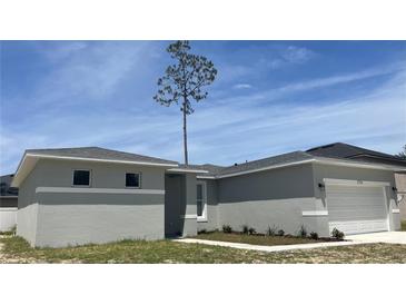 Charming single-story home featuring a two-car garage and modern architectural details at 1734 Sail Ct, Kissimmee, FL 34759
