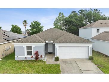 Charming single-story home with a well-maintained lawn and attached two-car garage, offering curb appeal at 252 Elgin Blvd, Davenport, FL 33897