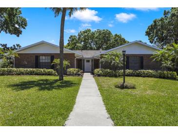 Charming brick home with a well-manicured lawn and lush landscaping at 2532 Waterview Pl, Windermere, FL 34786