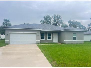 Charming single-story home with a well-manicured lawn and attached two-car garage at 3389 Sw 126Th Lane Rd, Ocala, FL 34473