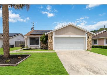 Charming single Gathering home boasts stone accents and a well maintained lawn at 357 Kantor Blvd, Casselberry, FL 32707