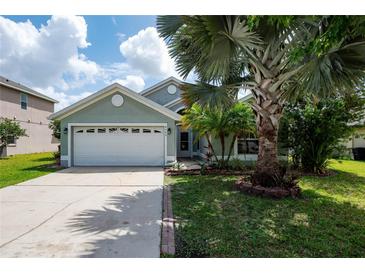 Charming one-story home featuring a well-manicured lawn and a two-car garage at 4060 Longworth Loop, Kissimmee, FL 34744