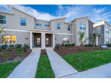 Modern townhome with well-maintained landscaping and stylish architectural details at 4220 Paragraph Dr, Kissimmee, FL 34746