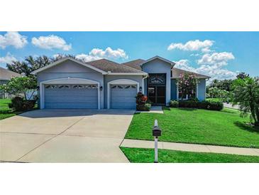 Charming single-story home with a well-manicured lawn and a three-car garage at 543 Auburn Hill Blvd, Auburndale, FL 33823