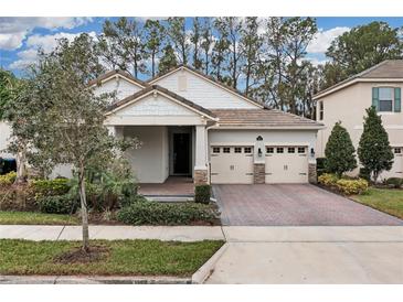 Charming single-story home with a brick driveway and a well-manicured front yard, showcasing its inviting curb appeal at 8972 Sonoma Coast Dr, Winter Garden, FL 34787