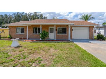 Charming single-story home with a brick exterior, well-maintained lawn, and covered front porch at 1001 Dora Ave, Tavares, FL 32778