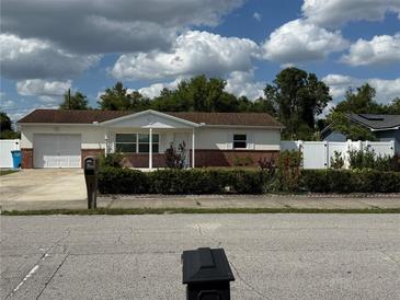 Charming single-story home with a brick facade and a well-maintained front yard at 1180 Baton Dr, Deltona, FL 32725