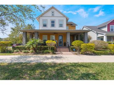 Charming two-story home with a cozy front porch and meticulously manicured landscaping at 13798 Walcott Ave, Orlando, FL 32827