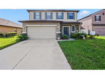 Inviting two-story home with a well-maintained lawn and a two-car garage at 2120 Lilipetal Ct, Sanford, FL 32771