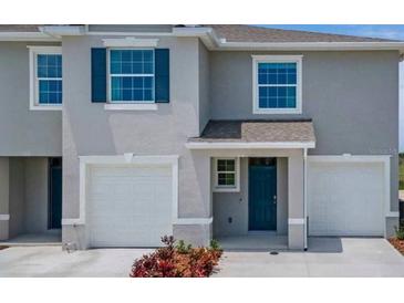 Charming two-story home with attached two-car garage and a welcoming front entrance at 2252 Tay Wes Dr, St Cloud, FL 34771
