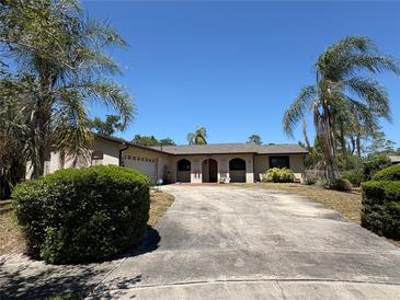 Charming single-story home with a well-maintained lawn and a spacious driveway framed by mature palm trees at 361 Tulip Trl, Casselberry, FL 32707