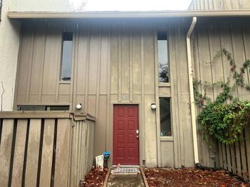 Charming townhome with a red front door and natural landscaping at 4838 Pebble Beach Dr # A, Orlando, FL 32811