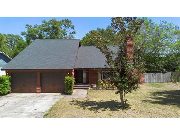 Charming home featuring a two-car garage and well-maintained landscaping at 825 Mellowood Ave, Orlando, FL 32825