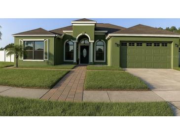 Charming single-story home with a well-maintained lawn, arched entryway, and attached garage at 8325 Sun Vista Way, Orlando, FL 32822