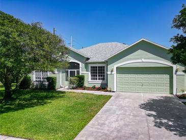 Charming home featuring a well-maintained lawn, fresh landscaping, and a two-car garage at 1157 Valley Creek Run, Winter Park, FL 32792