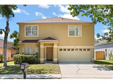 Two story home with a two car garage and covered front door and mailbox at 126 Knights Hollow Dr, Apopka, FL 32712