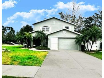 Charming two-story home with a well-manicured lawn and mature landscaping at 1309 Harms Way, Port Orange, FL 32129