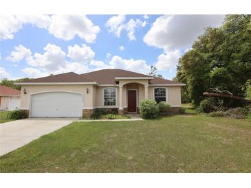 Charming single-story home with a two-car garage and well-maintained landscaping at 13157 Sw 35Th Cir, Ocala, FL 34473