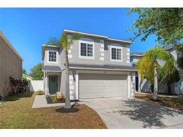 Charming two-story home boasts a well-manicured lawn, light-gray paint, and a welcoming front entrance at 1415 Sherbourne St, Winter Garden, FL 34787